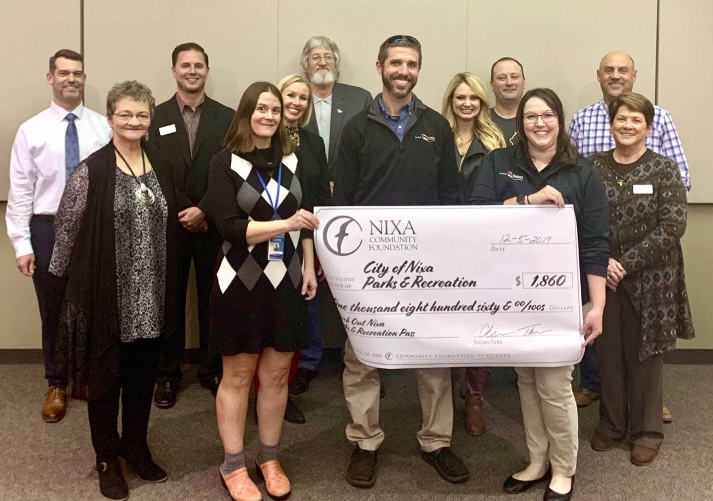 PARKS & REC
Officials with the Nixa Community Foundation on Dec. 5, 2019, present an $1,860 check to Nixa Parks & Recreation staff to fund a new program. In partnership with the Christian County Library, card holders will be able to obtain pool and fitness center passes at The X Center in 2020 and 2021. The foundation also distributed $2,300 to the Nixa Police Department for its Cops Connecting with Kids program and $1,950 for the city to purchase weather radios to give to the elderly.